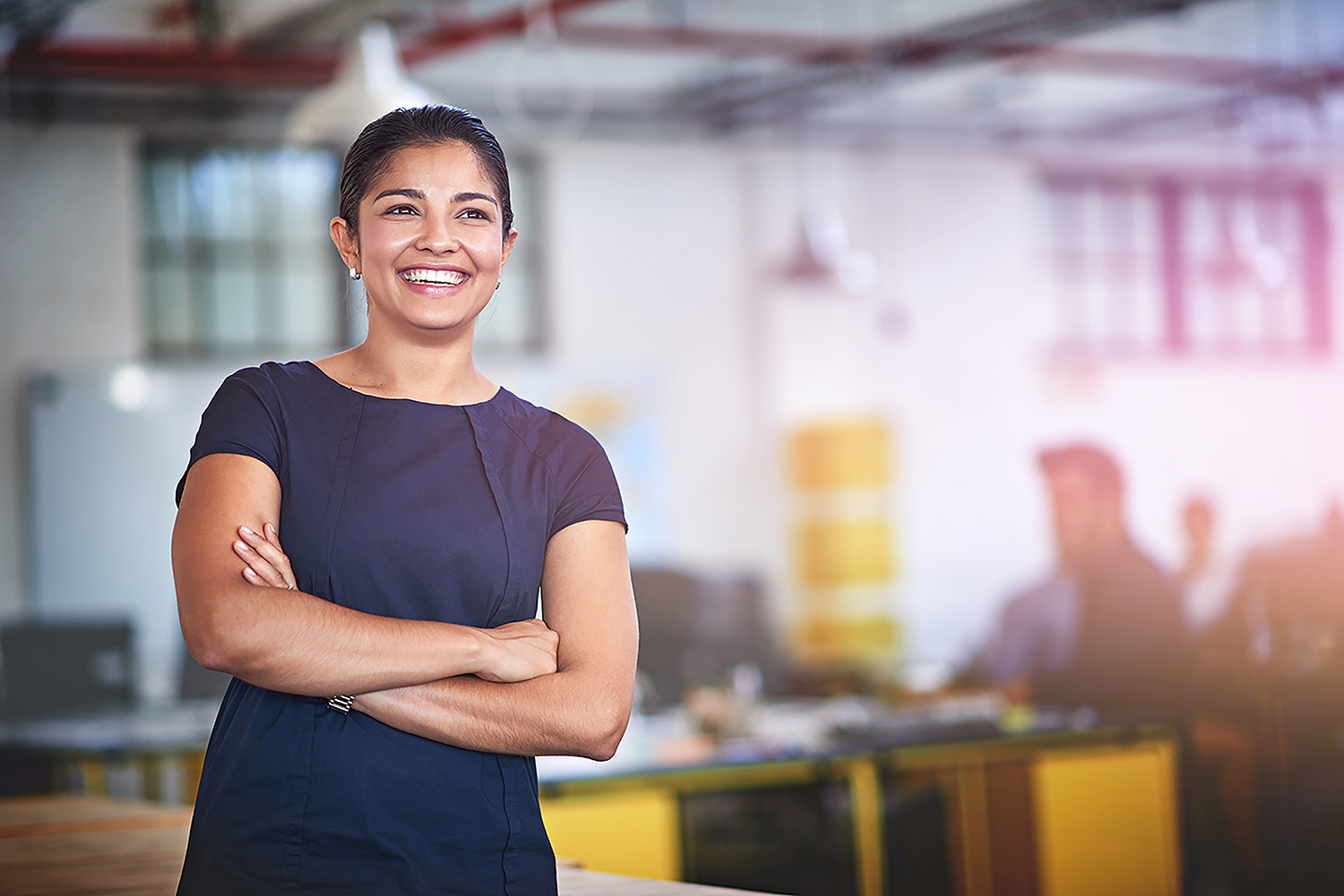 Woman with folded arms smiling