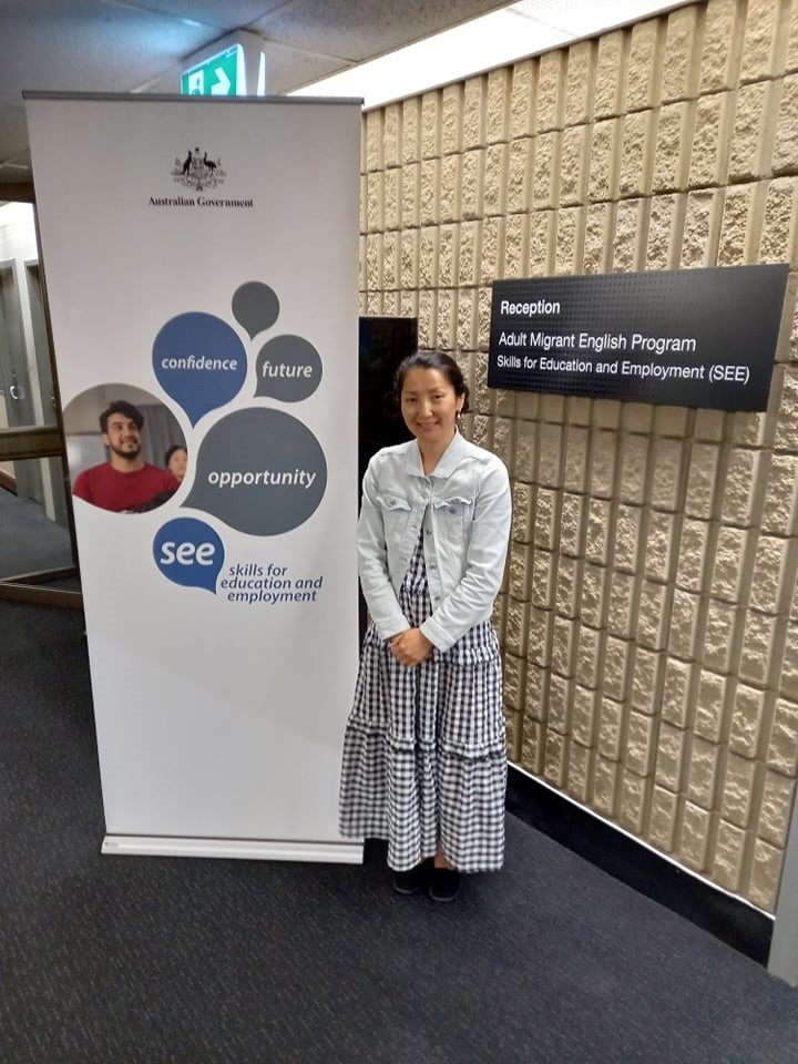Photo of Sainzul Batkhuu standing next to a Skills for Education and Employment banner.