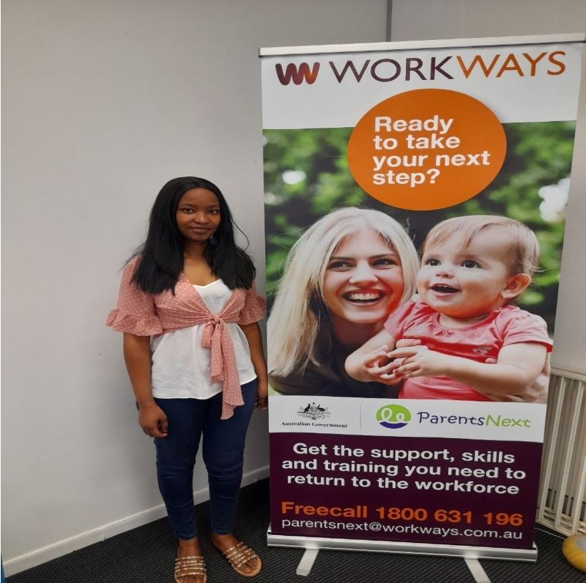 Grace standing next to a banner