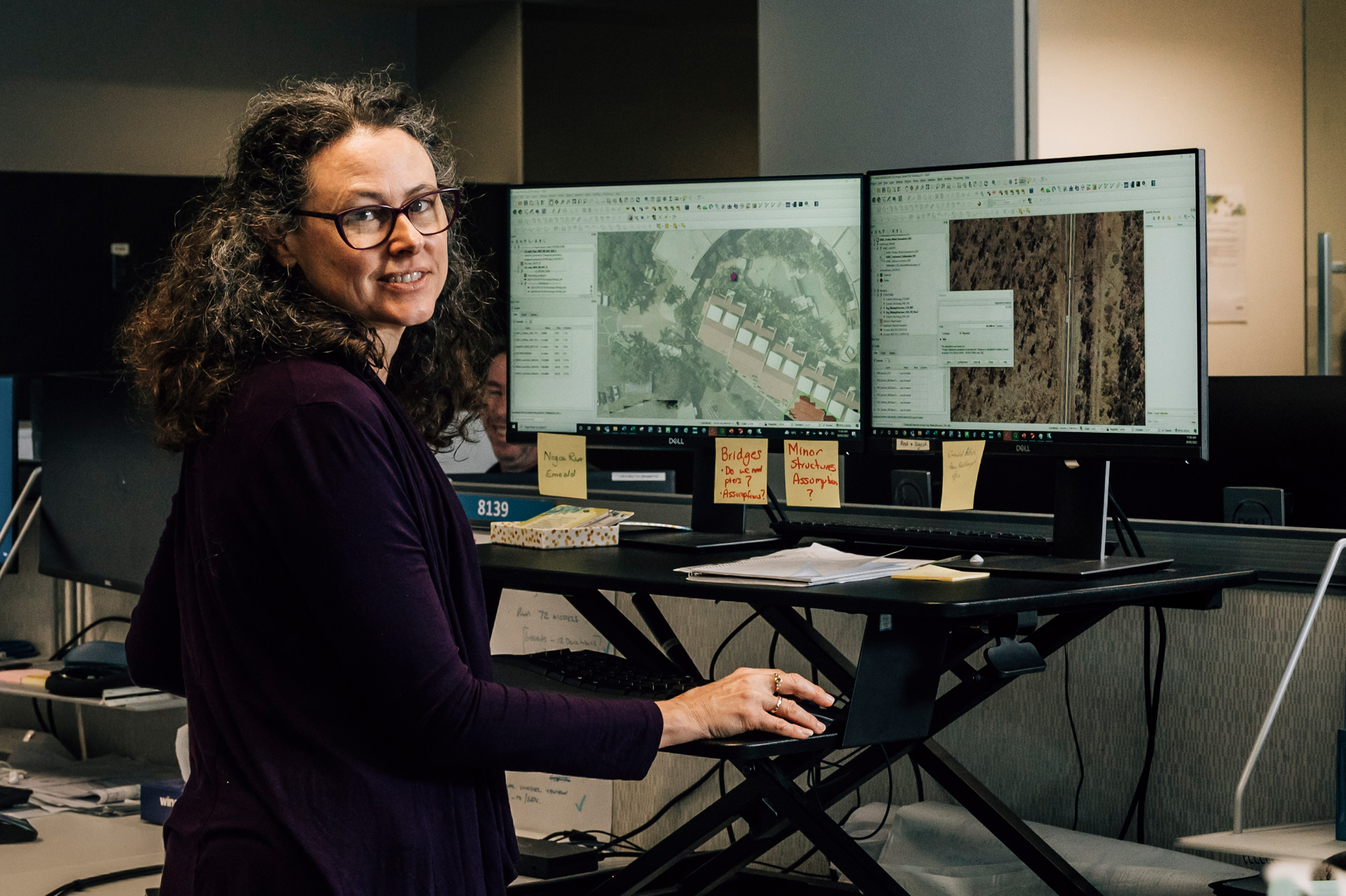 Image of a person standing at a computer desk