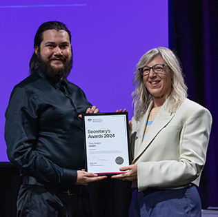 Troy Kuiper receiving a Secretary’s Award with Department Secretary Natalie James
