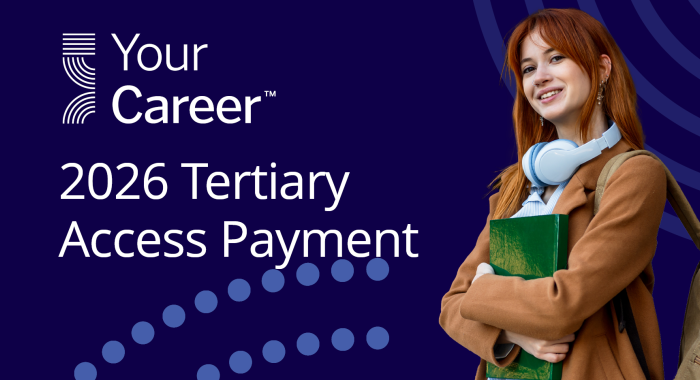 person holding books and smiling at camera