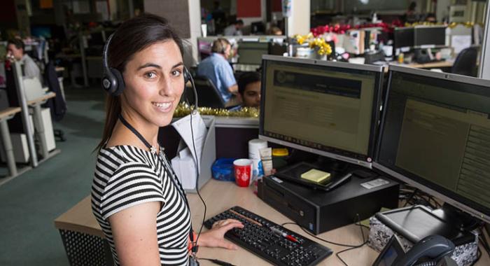 Contact Centre staff with headset at computer