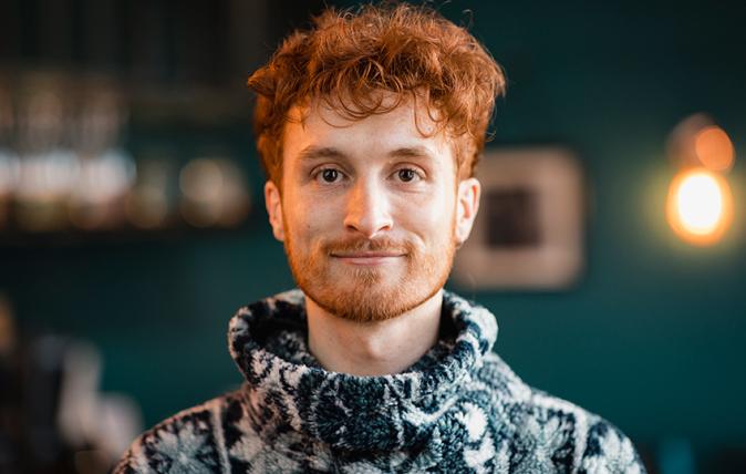 Headshot of a pleasant young man with ginger-hair.