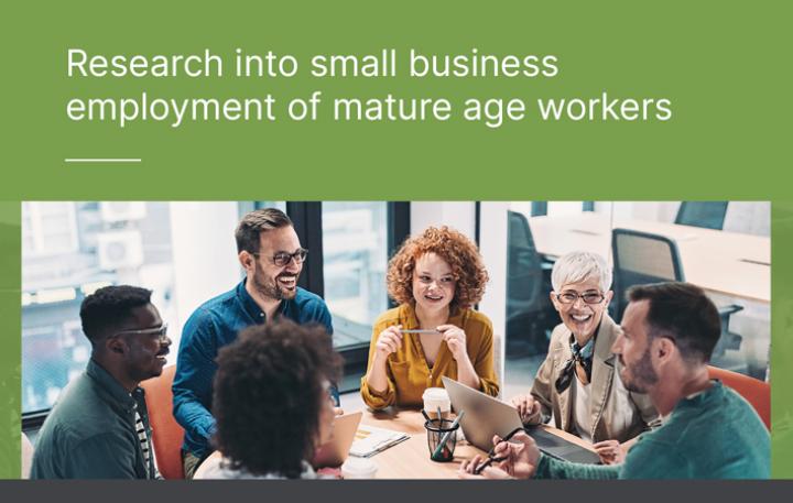 Six office workers enjoying a discussion while seated around a circular table. The caption positioned to the left reads: "Research into small business employment of mature age workers".