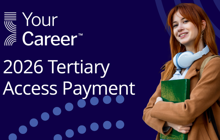 person holding books and smiling at camera