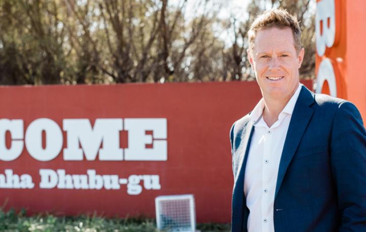 Senior Project Officer with Dubbo Regional Council Luke Cameron is smiling at the camera. He’s wearing a white shirt with a blue suit jacket