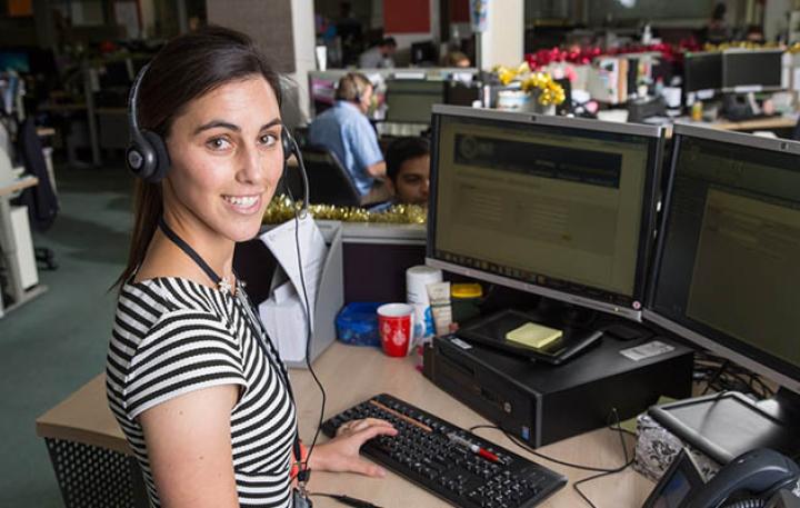 Contact Centre staff with headset at computer