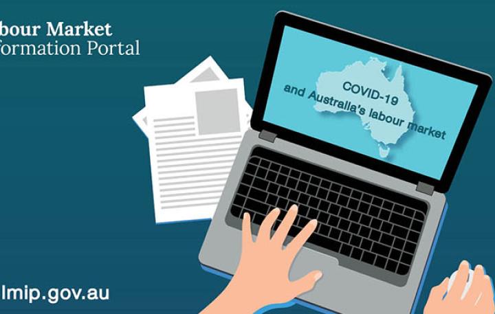 Person reading an online article on a laptop about COVID-19 and Australia’s labour market